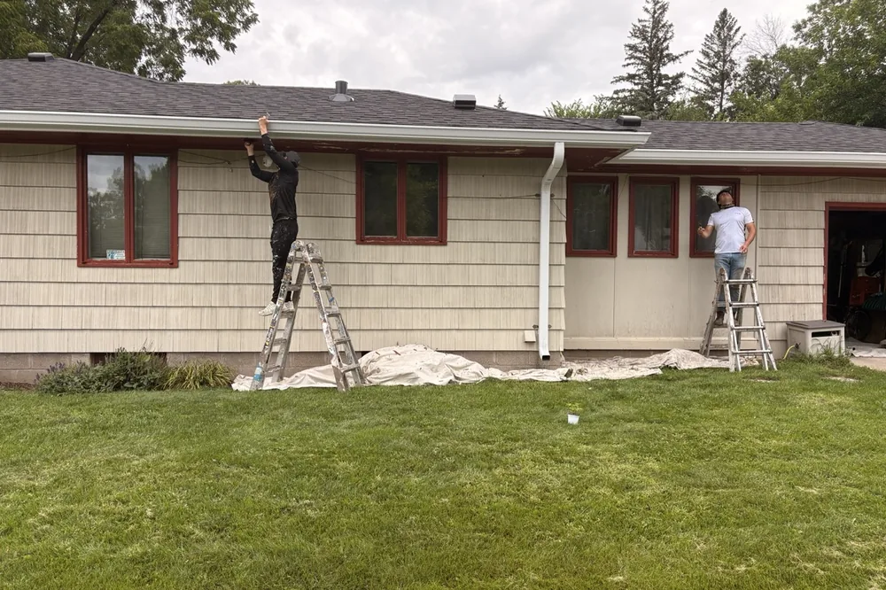 Smooth Painting crew painting the exterior siding and trim of a Minnesota home